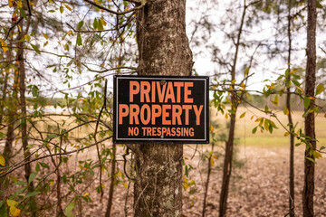 Private property no trespassing sign with outdoors background