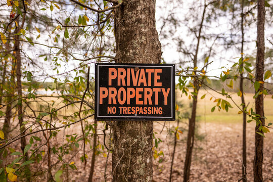 Private property no trespassing sign with outdoors background