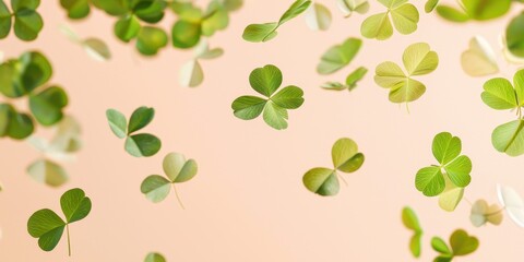 Obraz premium Floating delicate clover leaves on a light peach background