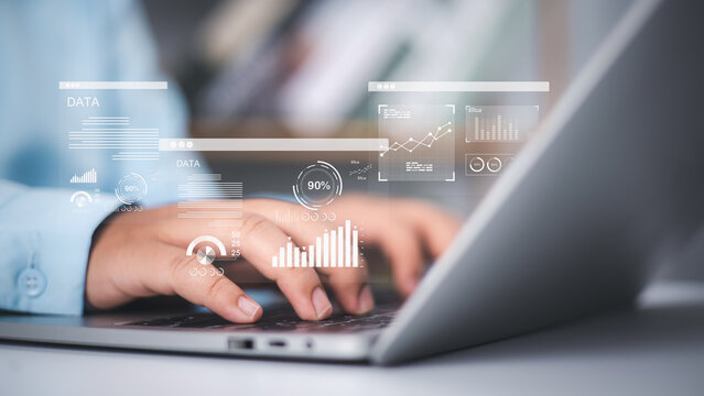 An analyst use a computer and dashboard for data business analysis and Management System with KPI metrics to the database for technology, Financial data analytics, Accounting record documents online.