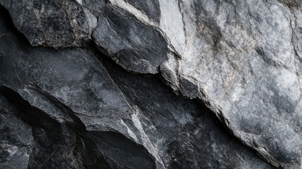 Dramatic close-up of a textured dark rock formation with sharp edges and details