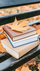 Stack of Books and Autumn Leaf on Park Bench, Fall Reading Season.