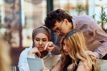 A Diverse MultiEthnic Group Reviewing Projects During a Work Break in a Caffee.