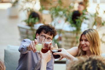 Diverse Teenagers Sitting in a Caffee, Toasting to a Work Moment of Celebration.