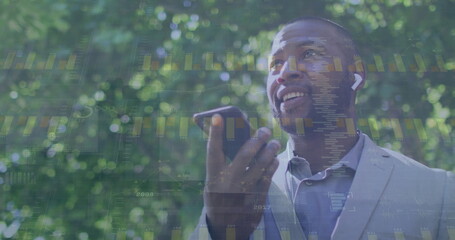 Fototapeta premium Image of diagrams and data processing over african american businessman talking on smartphone