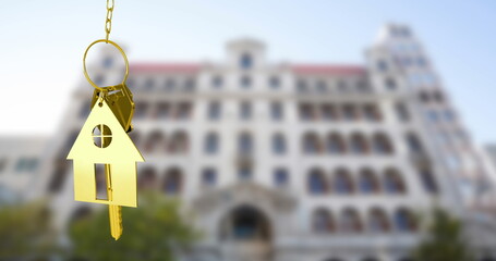 Image of golden key and house over white building