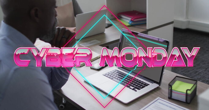 Image of cyber monday text over afrcian american businessman using laptop
