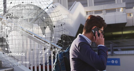 Image of data processing and globe over asian businessman talking on smartphone