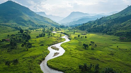 Serene mountain valley river winding through lush green fields