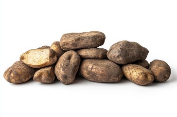 Obraz premium Freshly harvested potatoes in a rustic pile against a plain white background, showcasing their natural texture and earthy colors for culinary use.