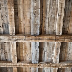 A rustic wooden ceiling featuring weathered beams with deep grain patterns, natural imperfections