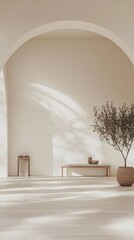 A white room with a large archway and a bench. A potted plant is in the corner