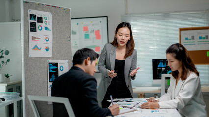 Business team working together on a project using data visualization and collaboration in a modern office