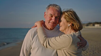 Portrait of couple of mature and old people enjoying summer at the beach looking to the camera taking a selfie together with the sunset at the background. Two active seniors traveling outdoors. - Powered by Adobe