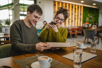 man and woman scan package card box together via mobile phone at cafe