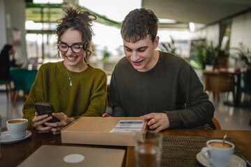 two students man and woman couple at cafe open post package box