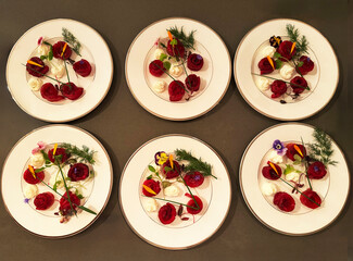 Rose-shaped beets with cheese, herbs and edible flowers