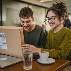 two students man and woman couple at cafe open post package box