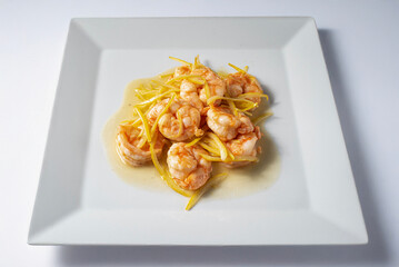 Prawns with lime and lemon Asian cuisine recipe served on a plate with a white background