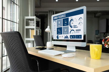 Human resources management software on computer screen helping human resources employee to manage recruitment, payroll, staff searching and KPI evaluation snugly