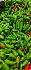 green stage of chili peppers (Capsicum annuum or Capsicum frutescens species), widely used in cooking for their spicy heat and sharp flavor
