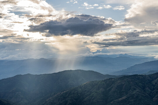 rain clouds in dark tones in the Andean mountain range of Colombia, a dramatic landscape scene. Powerful sunset lights and storm form.