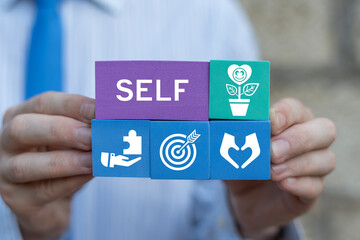 Business person holding colorful foam blocks sees text: SELF. Study, learn and explore self. Find...