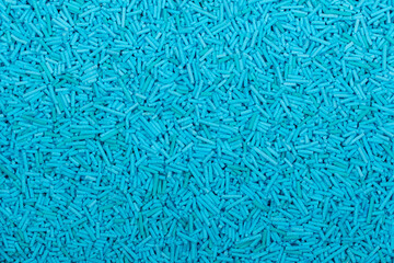 Close-up of uncooked blue vermicelli pasta, small cylindrical noodles scattered in a textured background. Detailed food texture ideal for culinary, packaging, and ingredient concepts.