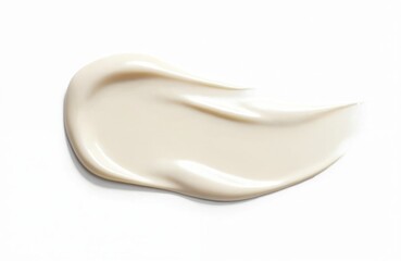 Smear of beige cream on white backdrop. Cosmetic beauty product sample lotion, skin care cream, foundation for face. Demonstrates smooth texture, skin tone palette for studio shot.