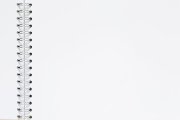 blank page of opened sketchbook with metallic bound