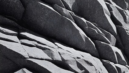  A rugged rock face displays dramatic angular formations with sharp edges and deep crevices.