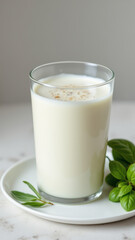 Freshly poured glass of milk with a sprinkle of cinnamon on top.