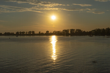 Golden Sunset Over Calm Lake With Tree Silhouettes, Peaceful Evening Reflection