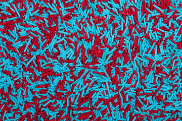 Fototapeta premium Vibrant Red and Turquoise Blue Sprinkles Background - Colorful Jimmies Texture for Baking Decorations, Confectionery Toppings, and Modern Dessert Garnishes