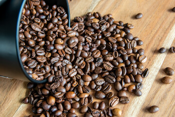 Box with coffe on the roasted coffe beans.