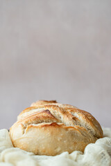 Rustic Artisan Sourdough Bread Loaf on Linen Cloth – Crusty Homemade Bread with Golden Brown Texture, Perfect for Food Bloggers, Bakeries, and Culinary Photography