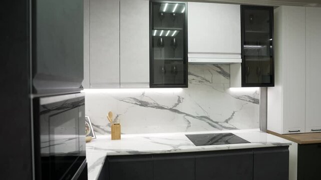 Luxurious kitchen interior featuring sleek white marble countertops, minimalist cabinets, and contemporary design elements blending functionality with elegance