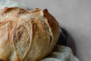 Rustic Artisan Sourdough Bread Loaf on Linen Cloth – Crusty Homemade Bread with Golden Brown Texture, Perfect for Food Bloggers, Bakeries, and Culinary Photography