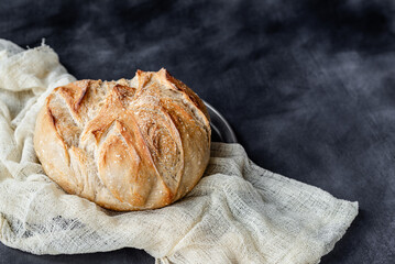 Rustic Artisan Sourdough Bread Loaf on Linen Cloth – Crusty Homemade Bread with Golden Brown Texture, Perfect for Food Bloggers, Bakeries, and Culinary Photography