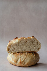 Artisan Sourdough Bread with Open Crumb – Crusty Homemade Loaf on Light Background for Bakeries, Food Bloggers, and Culinary Photography – Sliced in Half