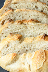 Overhead View of Sliced Artisan Sourdough Bread Arranged in a Pattern – Rustic Homemade Bread with Open Crumb and Golden Crust, Perfect for Food Bloggers and Culinary Design – Sourdough Texture