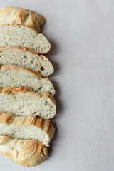 Overhead View of Sliced Artisan Sourdough Bread Arranged in a Pattern – Rustic Homemade Bread with Open Crumb and Golden Crust, Perfect for Food Bloggers and Culinary Design – Sourdough Texture