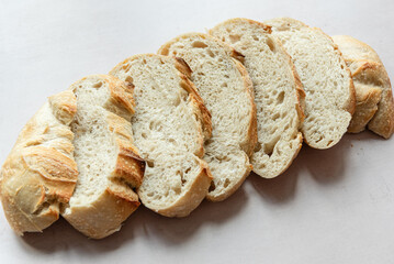 Overhead View of Sliced Artisan Sourdough Bread Arranged in a Pattern – Rustic Homemade Bread with Open Crumb and Golden Crust, Perfect for Food Bloggers and Culinary Design – Sourdough Texture