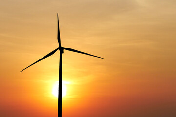 Renewable Energy Wind Turbine Silhouette Against Vibrant Sunset Sky for Sustainable Power and...