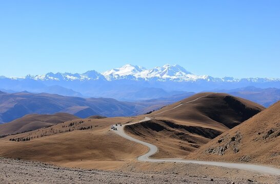 A panoramic view of the Andes Mountains from Cusco, with snow-capped peaks in the distance and an open road leading to them.  reread in the mountains of Ladakh