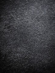 Dramatic black granular stone surface, rough texture studio shot
