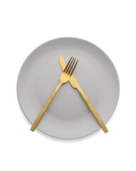 White plate with gold cutlery on the table