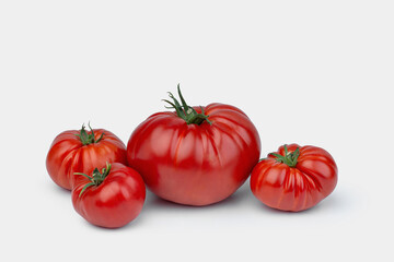 Red and pink tomatoes on a white background