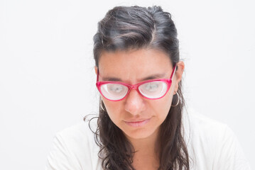Fototapeta premium Woman with contact lenses looking down thoughtfully.