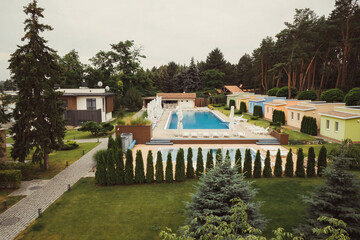 Country complex with a swimming pool and holiday cottages.